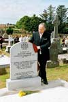 Minister of Defence Michael Smith unveils the headstone on the grave of Cornelius Coughlan, V.C.